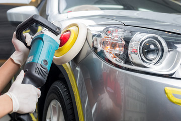 Car polishing series : Worker waxing grey car