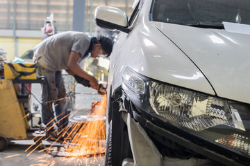 Auto body repair series : Mechanic grinding car body