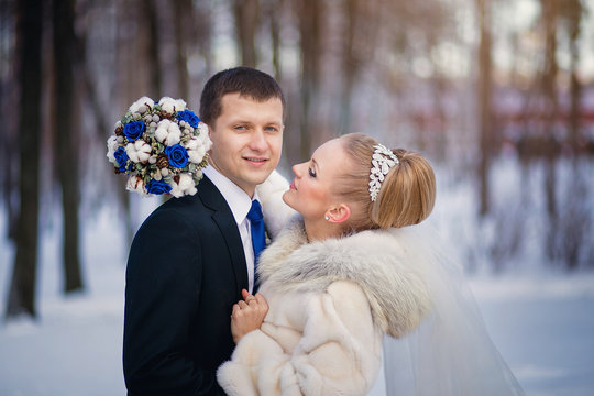 Lovers bride and groom in winter day outdoors