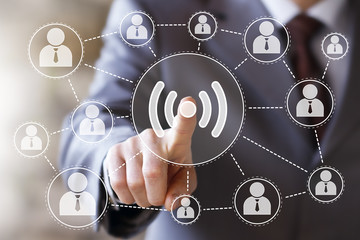 Businessman push button WiFi icon web