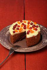 Homemade chocolate cake with fresh cranberries, sea-buckthorn an