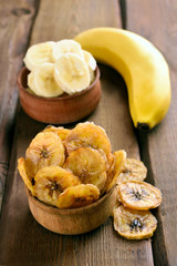 Banana chips on wooden table