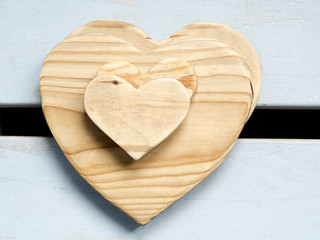 stack of wooden heart shapes on wooden board
