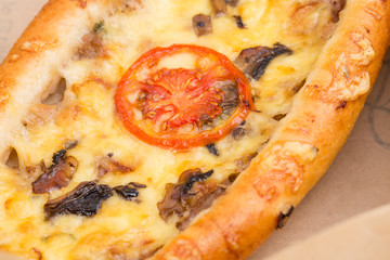 Slice of delicious american pizza with mushrooms.