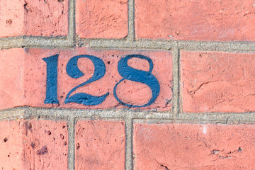 House number 128 painted sign