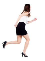 back view of running  woman  in  dress.