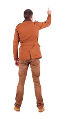 Naklejka premium Back view of man in jacket pointing.