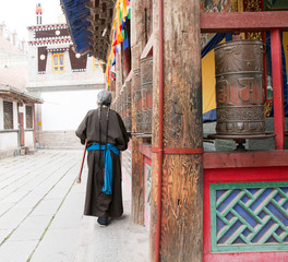 one female Tibetan prays at Kumbum Monastery in Qinghai Province, China. - 100941400