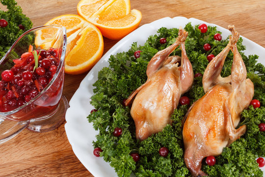 Carcasses of quail roasted with cranberry and parsley