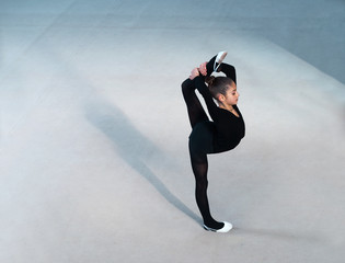 beautiful girl in a black suit makes the balance