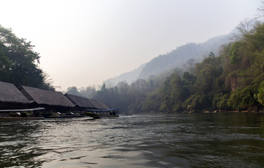 Floating Raft Hotel by an early misty morning on the River Kwai in Thailand.