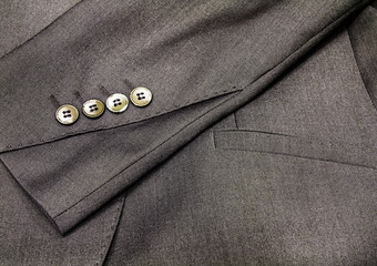 Row of buttons on the sleeve of a tailor made suite