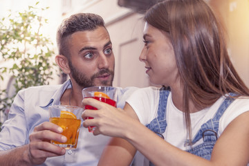 young couple takes a drink in a downtown bar