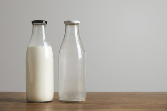 Simple vintage bottles with fresh milk and empty