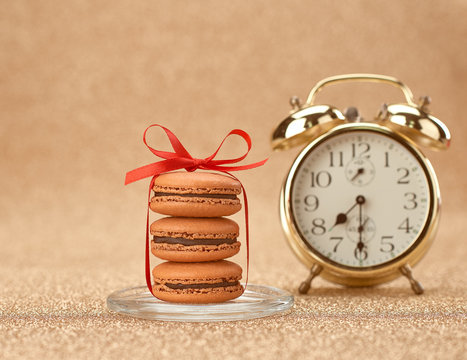 Macarons. Gold stylish alarm clock, breakfast time