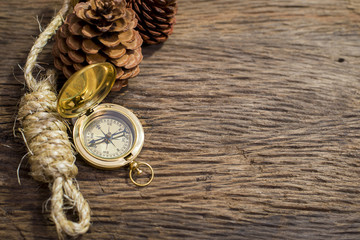 Old Compass and rope on wood background
