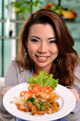 Thai woman serving delicious food