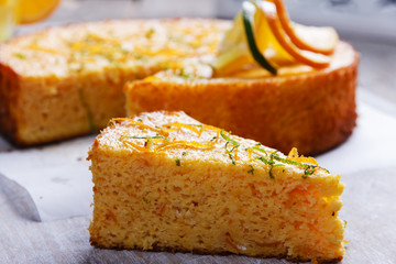 Home made whole testy orange cake on a wooden surface