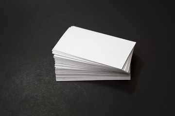 blank business cards stack up on Black background