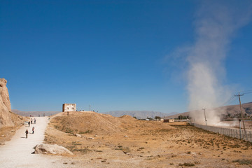 Natural phenomenon of tornado in a sandy valley with road to Persepolis. UNESCO World Heritage Site