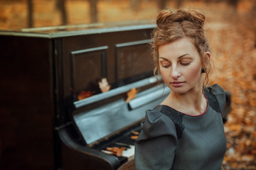 Fototapeta na wymiar Autumn music woman with piano