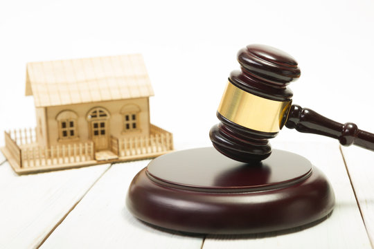 Auction. Law. Miniature House on wooden table and Court Gavel