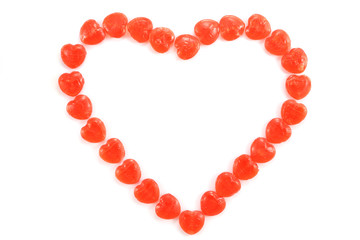 Heart shape made of candies isolated on white background