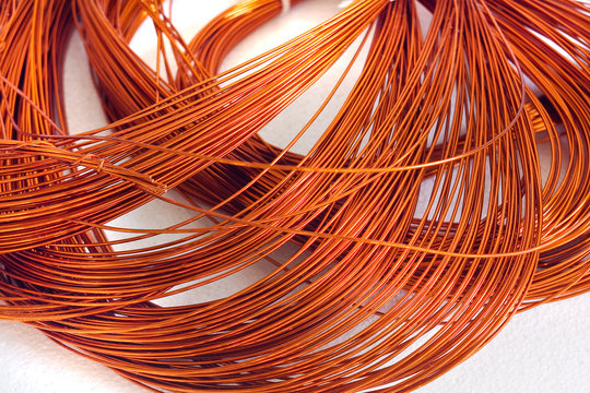 Skein copper wire on white background. Copper wire winding, coil, spool section of the electric machine - generator or motor
