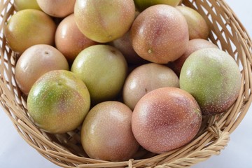 A basket of passion fruits on a white background