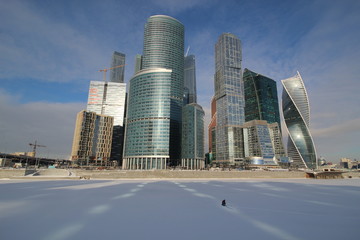 Visas in winter, modern skyscrapers and a lone fisherman on the ice