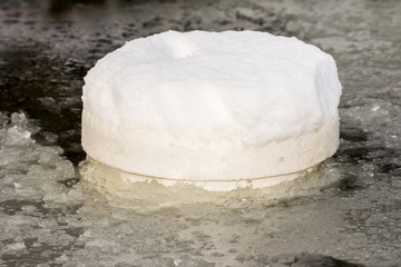 Floating ice preventer in a frozen pond