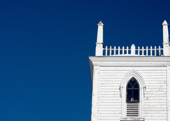 Fototapeta na wymiar old wooden church steeple with blue sky on a sunny day