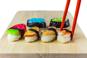 Sushi with chopsticks on wood