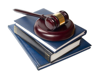 Law book with a wooden judges gavel on table in courtroom 