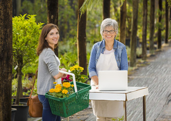 Worker and customer in a green house