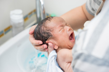 Asian newborn baby having a bath © alice_photo