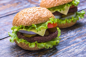 Big burger with beef cutlet and fresh vegetables isolated on white backgound