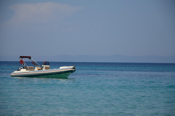 Fototapeta na wymiar White Powerboat on Turquoise Sea