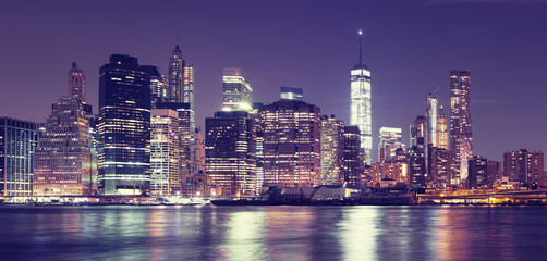 Fototapeta na wymiar Vintage toned New York City at night panoramic picture, USA.