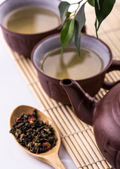 Green Tea set on a bamboo mat on white background
