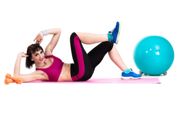 Fototapeta na wymiar Young smiling woman makes exercise with fitball