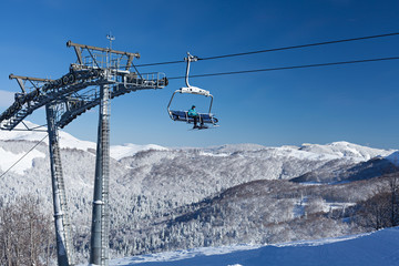Ski lift with seats going over the mountain
