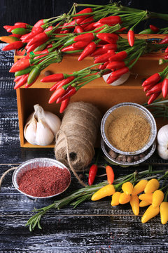 cooking spices in a box on the old wooden background rustic style