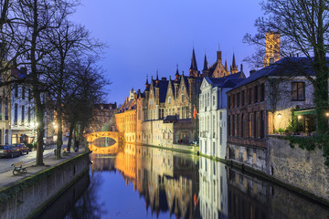Night scene of historic medieval buildings along a canal in Bruges