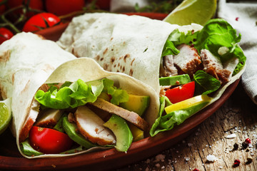 Fresh roll shawarma (doner) with meat, avocado, cherry tomatoes,