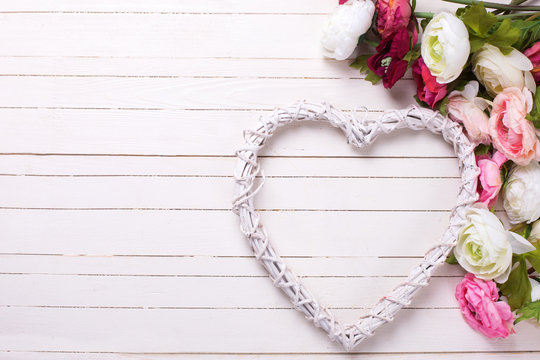 Flowers in pink colors and white decorative heart