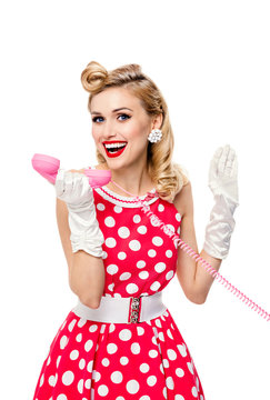 smiling woman with phone, dressed in pin-up style dress