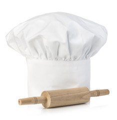 Original cooks cap with wooden rolling-pin. Chef's hat close-up isolated on a white background.