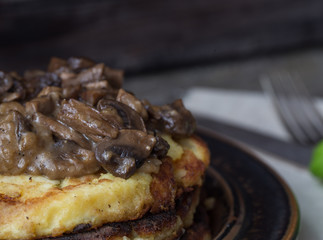 Fried potato pancakes with mushrooms. Traditional Czech food. Preparing homemade food