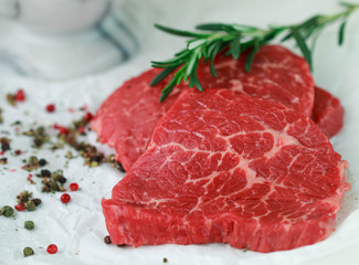 Raw beef chops with spices and rosemary